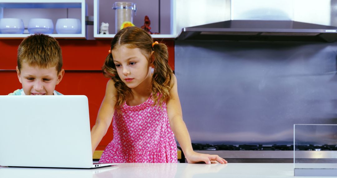 Children Using Laptop in Modern Kitchen - Free Images, Stock Photos and Pictures on Pikwizard.com