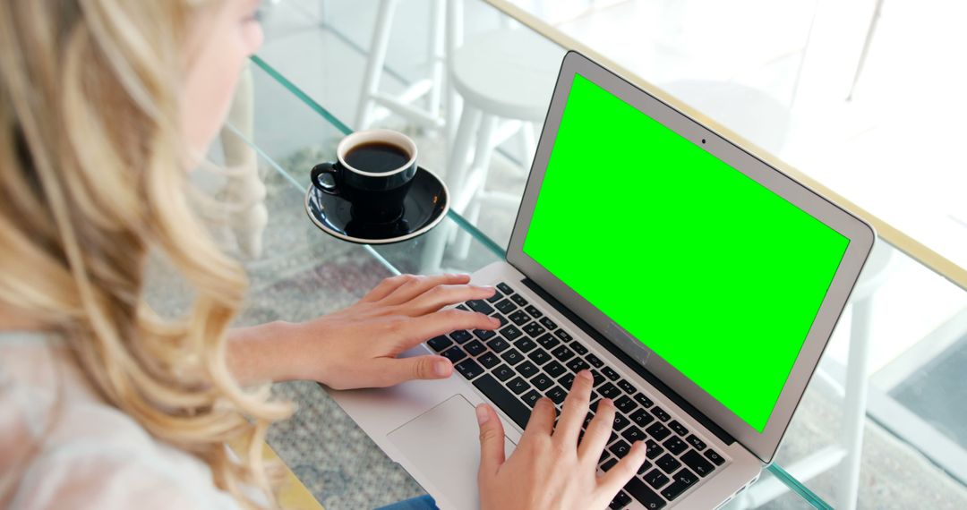 Woman Working on Laptop with Green Screen in Cafeteria - Free Images, Stock Photos and Pictures on Pikwizard.com