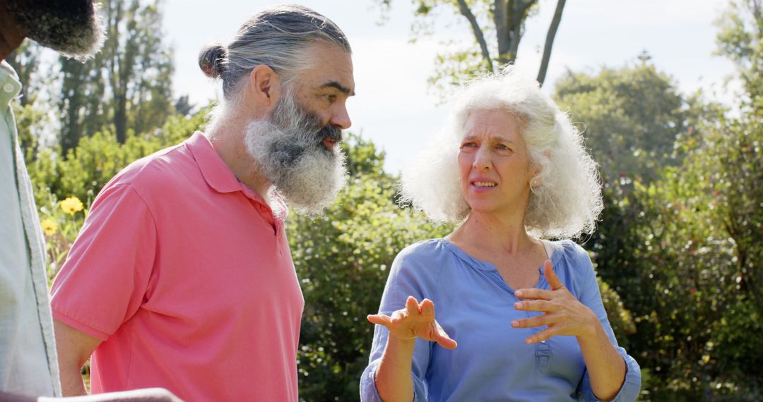 Senior Friends Conversing in Sunny Garden