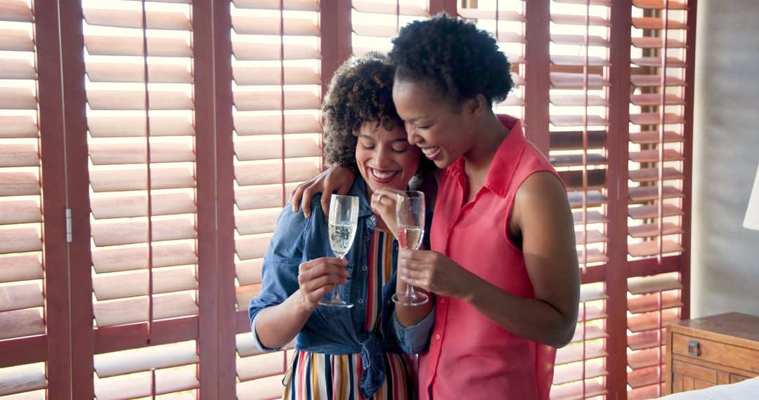 Two Women Celebrating Engagement with Champagne at Home