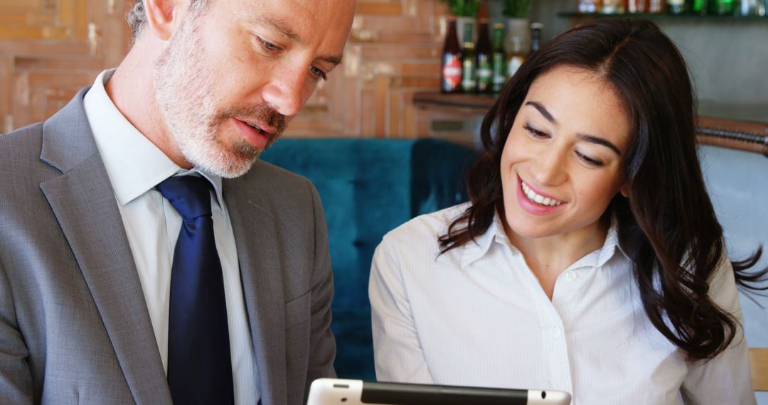 Professional Mentorship with Businessman and Young Woman Using Tablet