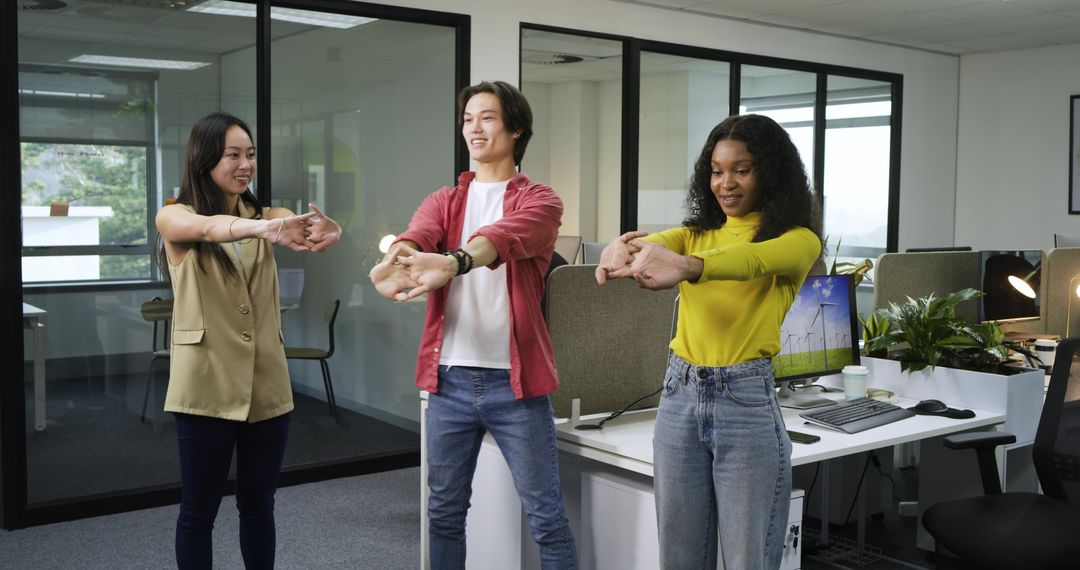 Diverse Team Stretching Wrist in Modern Office for Ergonomic Wellness