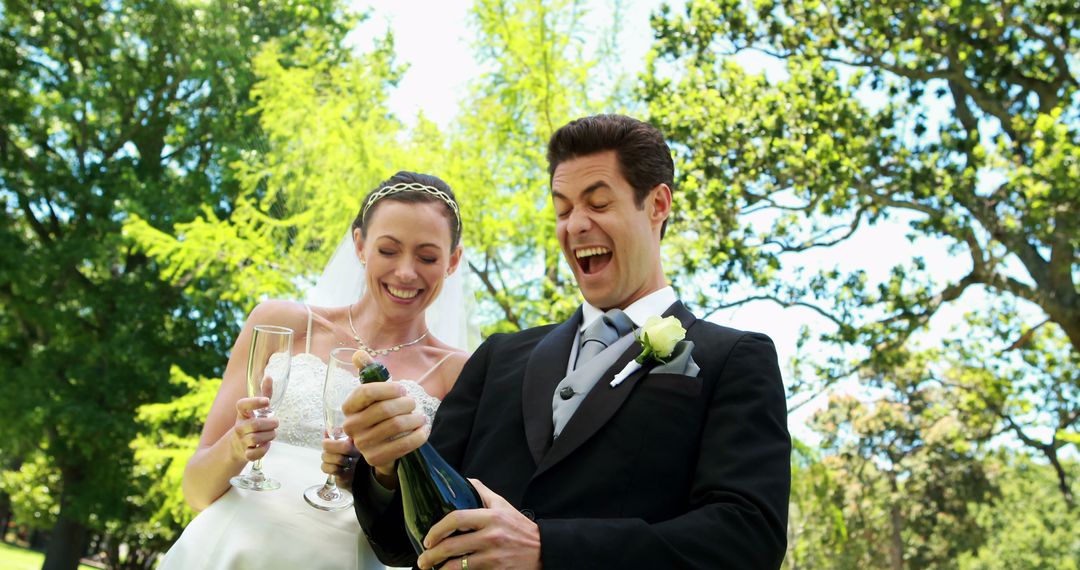 Just Married Couple Celebrating with Champagne Outdoors - Free Images, Stock Photos and Pictures on Pikwizard.com