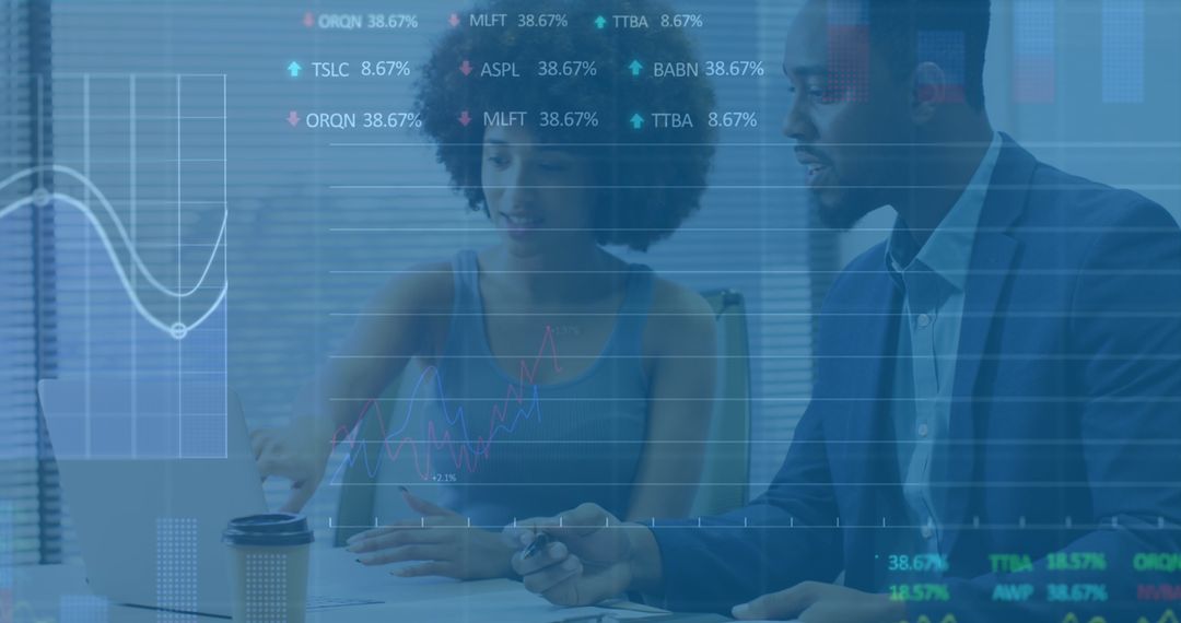 Finance Professionals Analyzing Data on Laptop with Financial Graphs Overlay - Free Images, Stock Photos and Pictures on Pikwizard.com