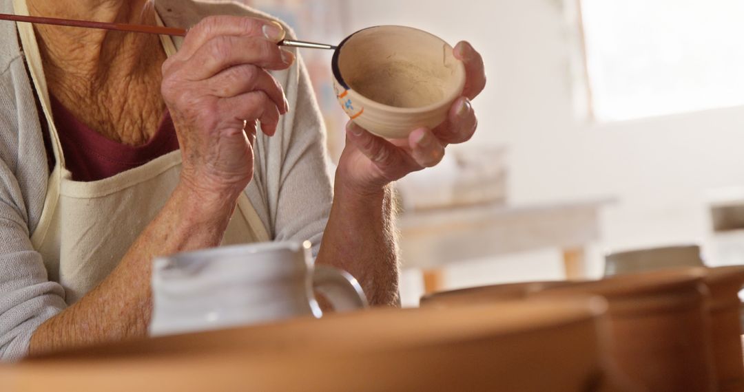 Elderly Artist Painting Pottery in Art Studio - Free Images, Stock Photos and Pictures on Pikwizard.com