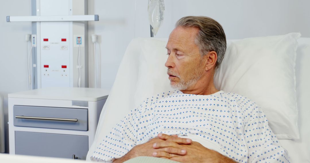 Elderly Male Patient Resting in Hospital Bed - Free Images, Stock Photos and Pictures on Pikwizard.com