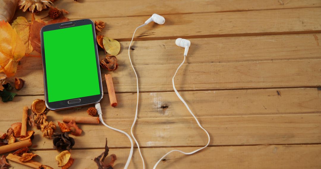 Smartphone With Green Screen and Earbuds on Rustic Wooden Table - Free Images, Stock Photos and Pictures on Pikwizard.com