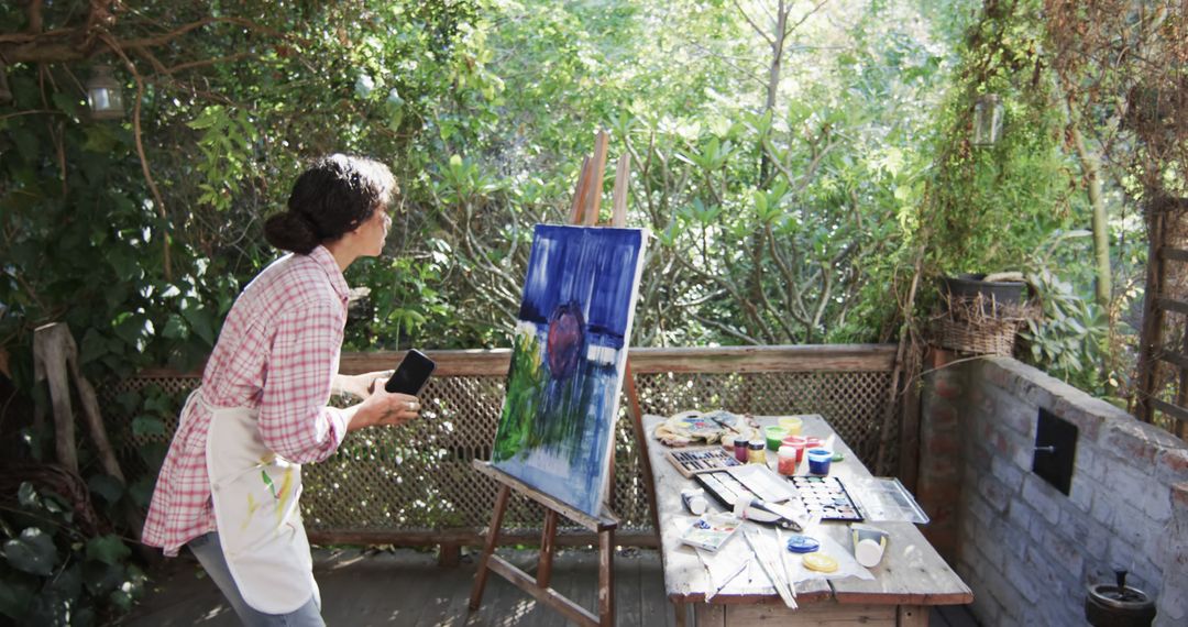 Woman Paints Colorful Landscape on Canvas Outdoors - Free Images, Stock Photos and Pictures on Pikwizard.com