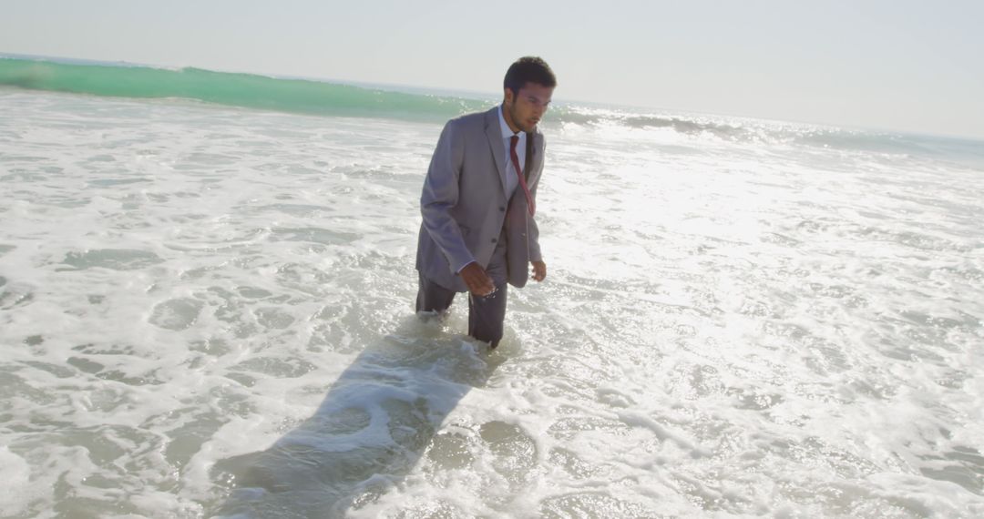 Businessman in Suit Walking Through Ocean Waves - Free Images, Stock Photos and Pictures on Pikwizard.com