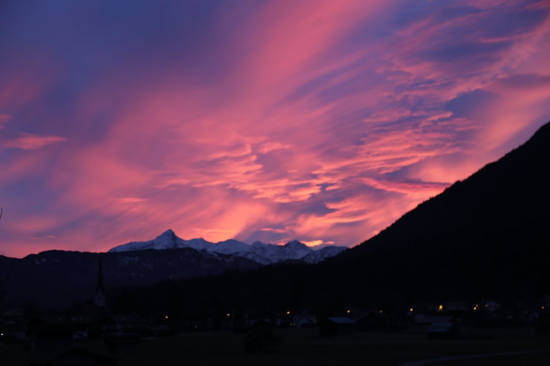Vibrant Sunset Over Snow-Capped Mountains and Village - Free Images, Stock Photos and Pictures on Pikwizard.com