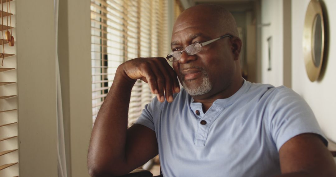 Thoughtful Middle-aged African-American Man Pondering at Home - Free Images, Stock Photos and Pictures on Pikwizard.com