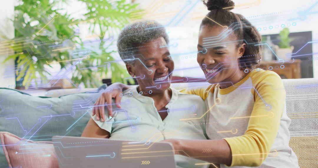 Smiling daughter pointing at laptop with mother learning together using AR overlay