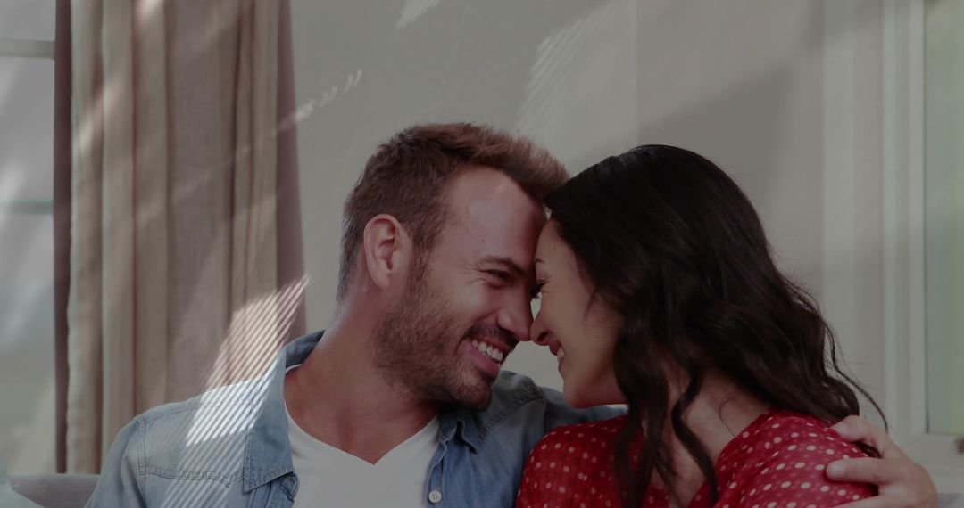 Happy Couple Embracing Affectionately on Cozy Sofa at Home