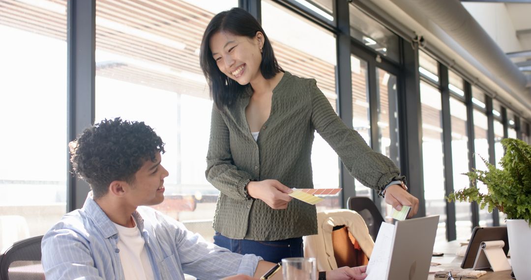 Creative Team Discussing Color Swatches in Modern Office