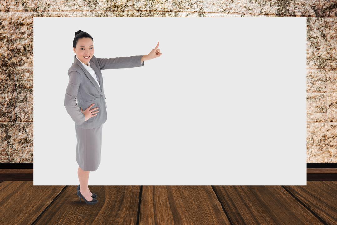 Businesswoman Pointing at Blank Billboard in Modern Office Setting - Free Images, Stock Photos and Pictures on Pikwizard.com