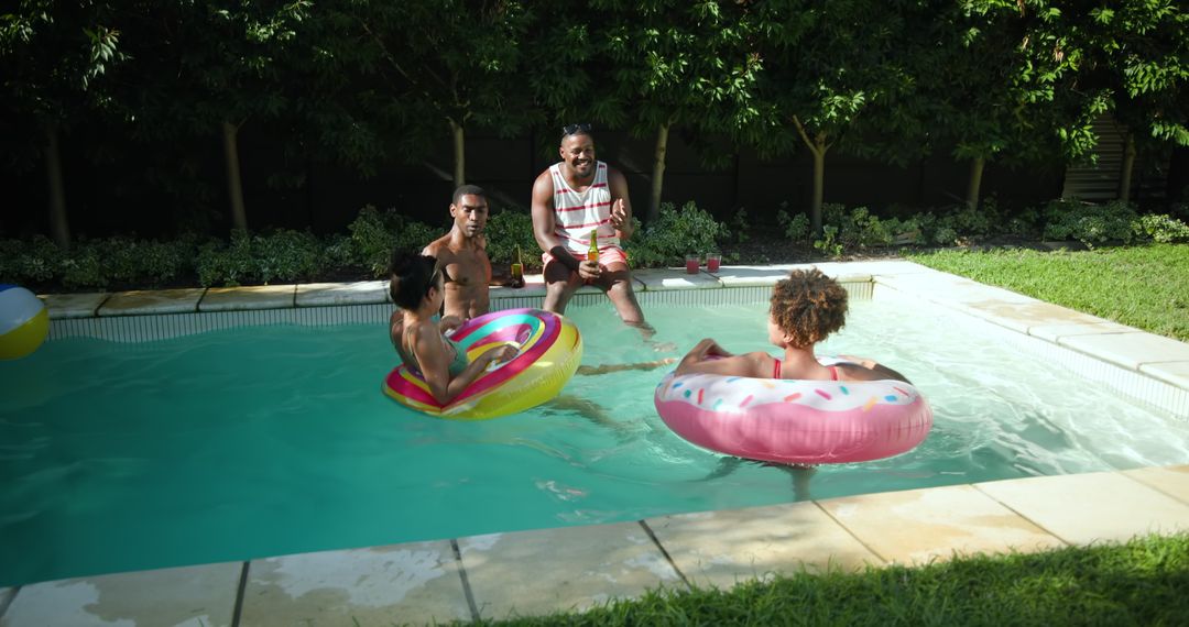 Friends Enjoying Summer in Backyard Pool with Inflatable Floats