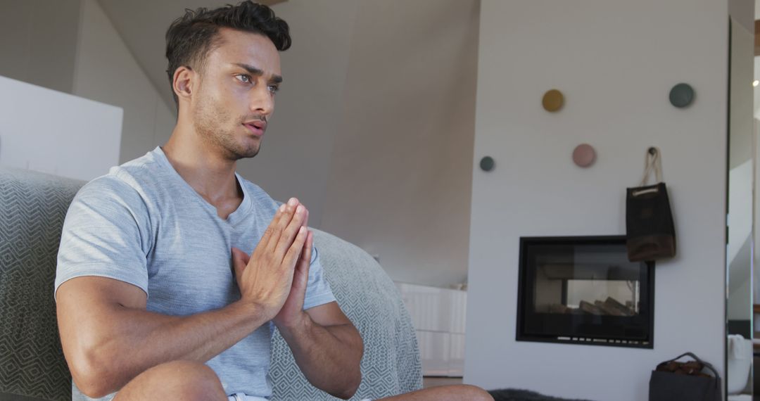 Man Practicing Meditation in Modern Living Room - Free Images, Stock Photos and Pictures on Pikwizard.com