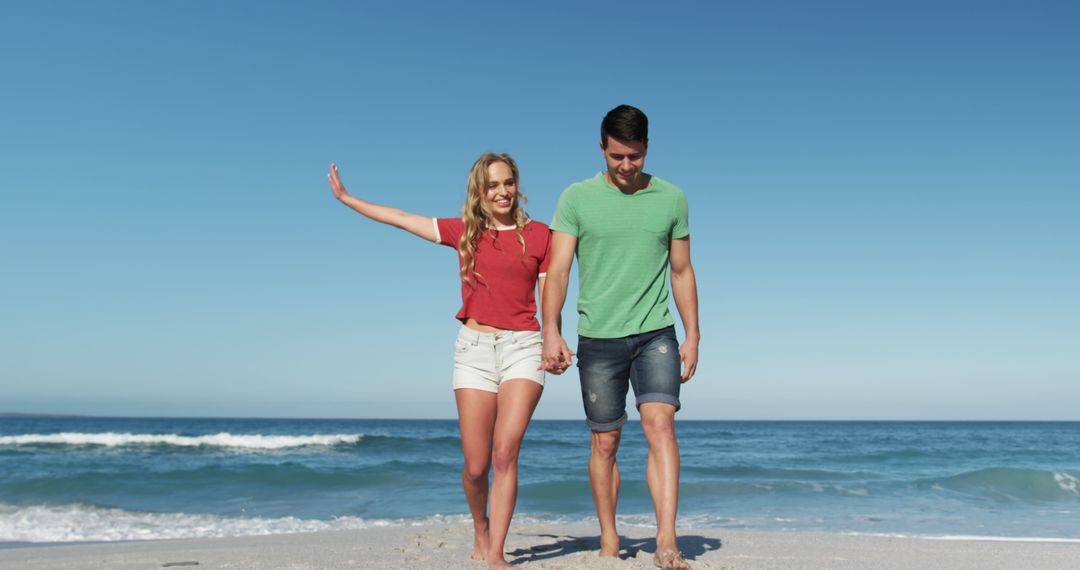 Happy Couple Holding Hands and Walking on Beach Shore - Free Images, Stock Photos and Pictures on Pikwizard.com