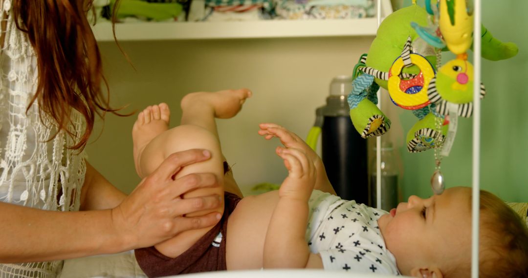 Mother Changing Diaper of Baby in Nursery - Free Images, Stock Photos and Pictures on Pikwizard.com