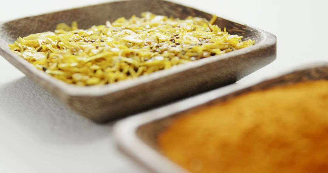 Close-up of yellow spices in square ceramic bowls - Free Images, Stock Photos and Pictures on Pikwizard.com