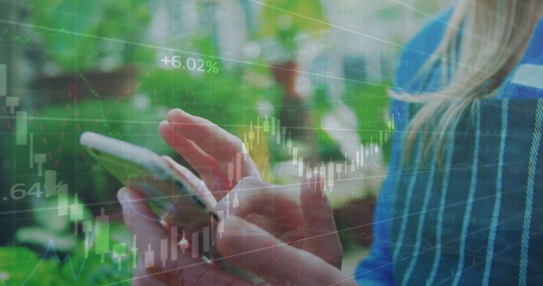 Woman Using Smartphone Overlaid with Stock Market Graphs