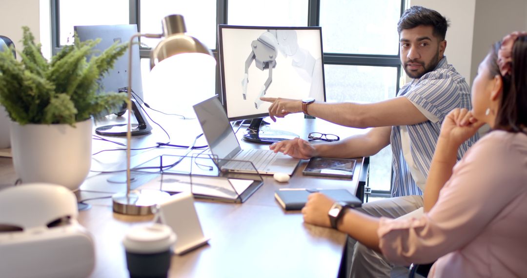 Engineers Collaborating on Robot Design in Office