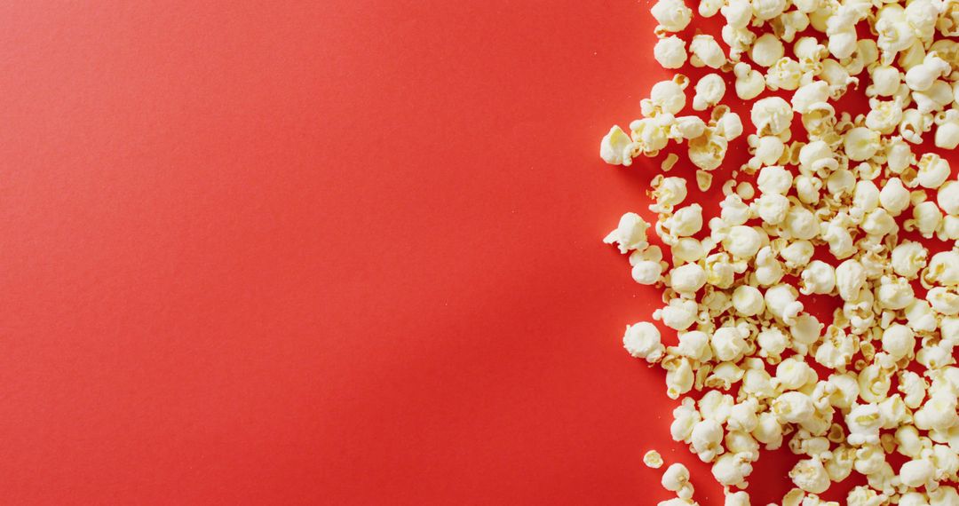 Close-Up of Popcorn on Vibrant Red Background for Celebrations