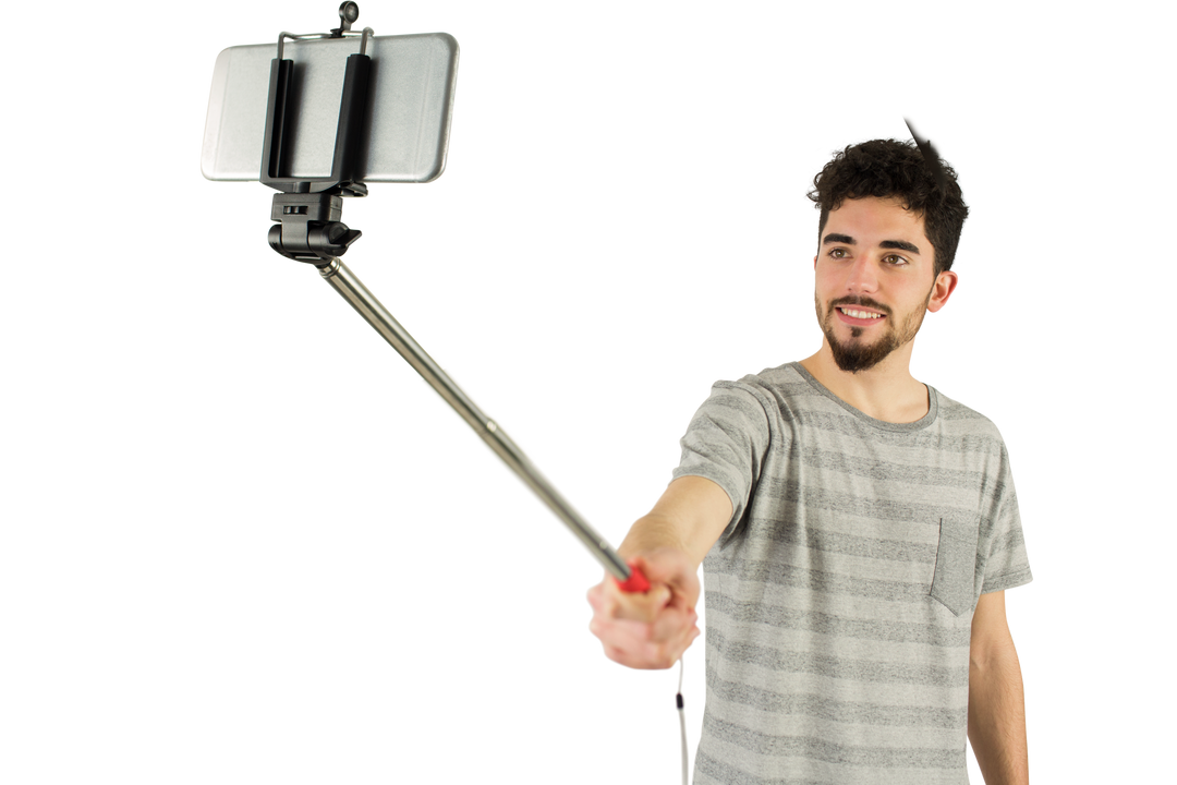 Transparent casual young man taking selfie with selfie stick studio shot - Download Free Stock Images Pikwizard.com