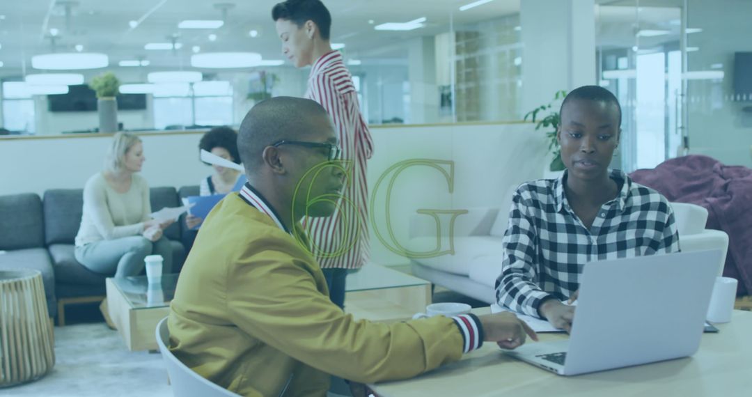 Team Collaborating in Modern Open Office Workspace with Technology