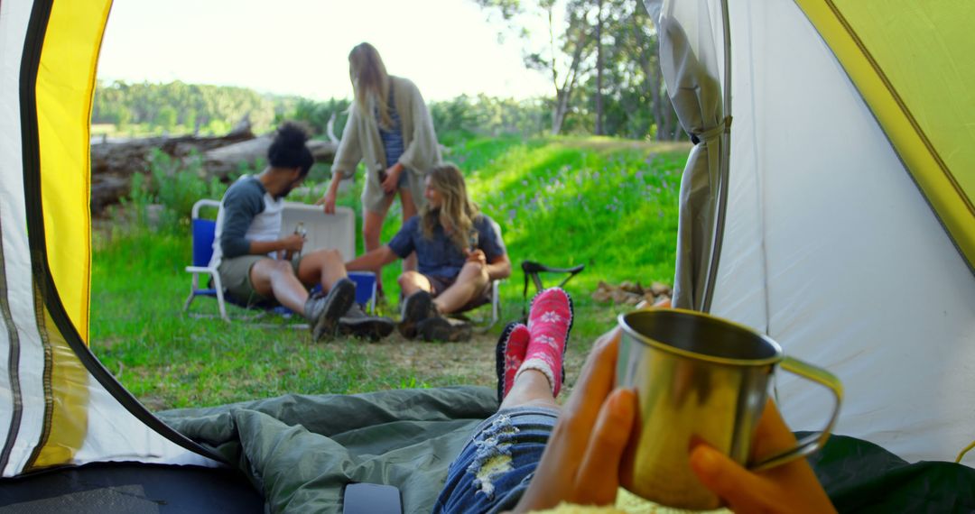 Group of Friends Relaxing at Campsite During Sunny Day - Free Images, Stock Photos and Pictures on Pikwizard.com