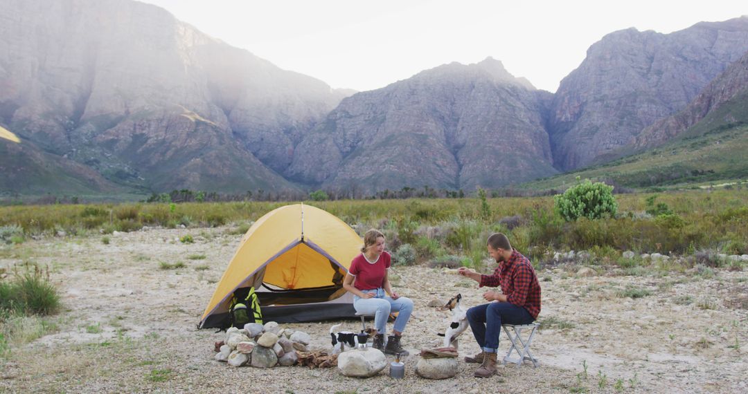 Couple Camping in Scenic Mountain Landscape with Tent and Dog - Free Images, Stock Photos and Pictures on Pikwizard.com