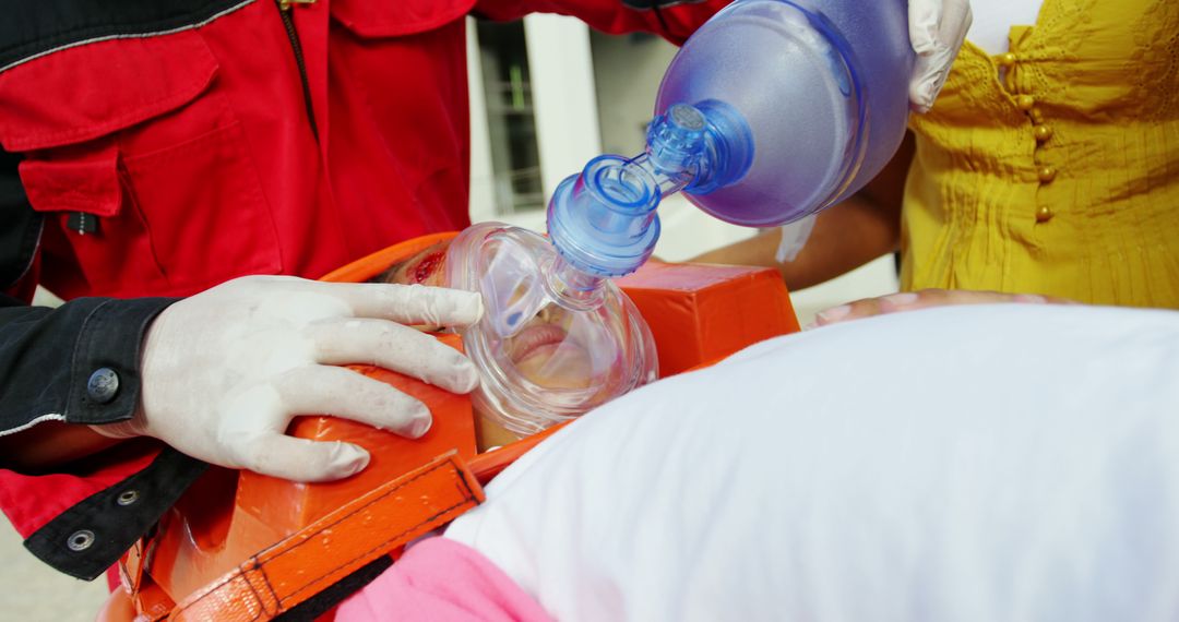 Emergency responders performing CPR with ventilation mask - Free Images, Stock Photos and Pictures on Pikwizard.com