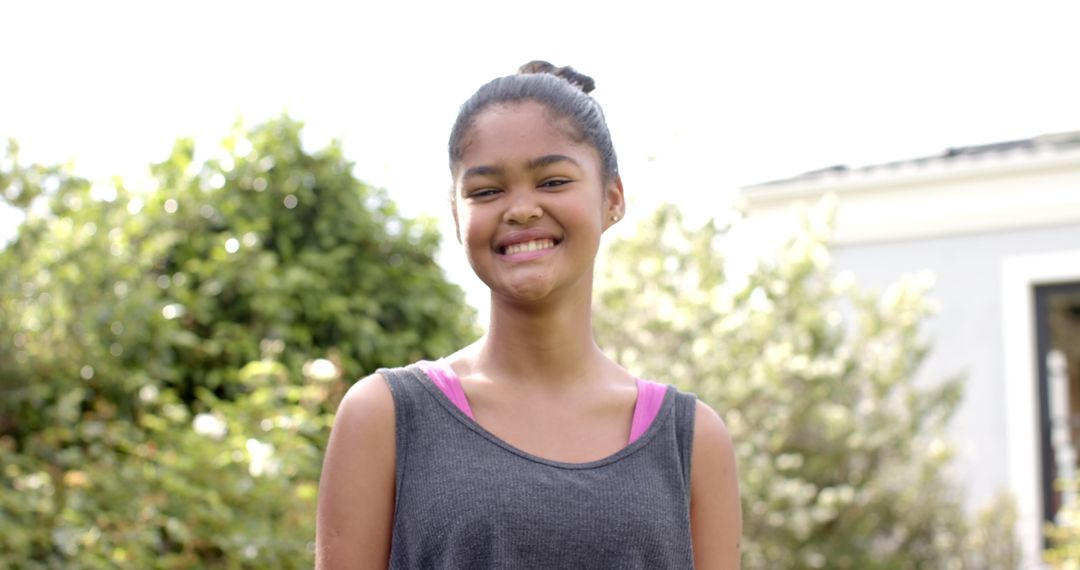Smiling Girl Enjoying Sunny Day in Garden
