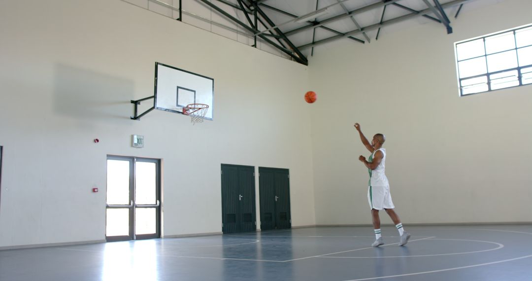 Man Perfecting Jump Shot in Indoor Basketball Gym