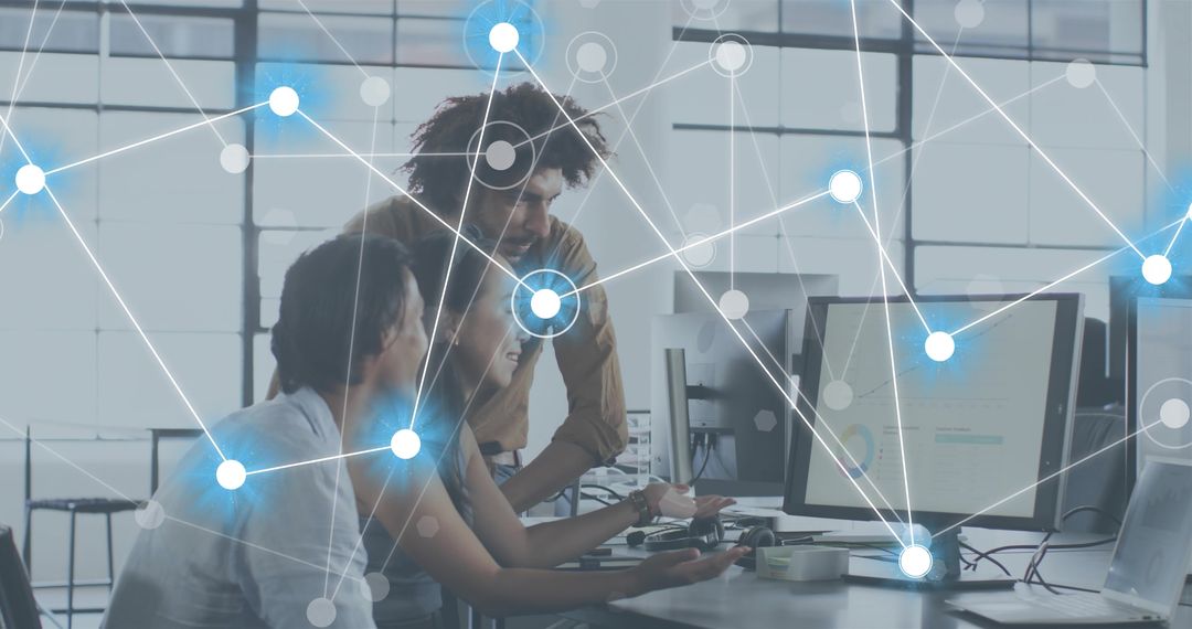 Team collaborating on data dashboards with glowing network overlay in modern workspace