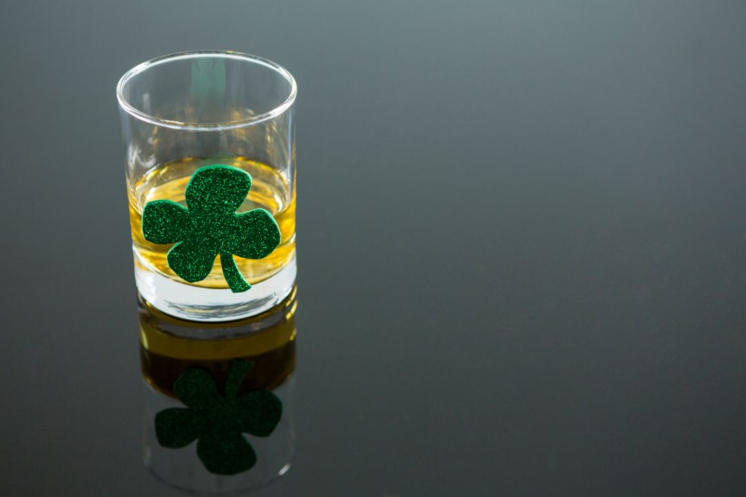 St. Patrick's Day Whiskey Glass with Shamrock on Grey Background - Free Images, Stock Photos and Pictures on Pikwizard.com