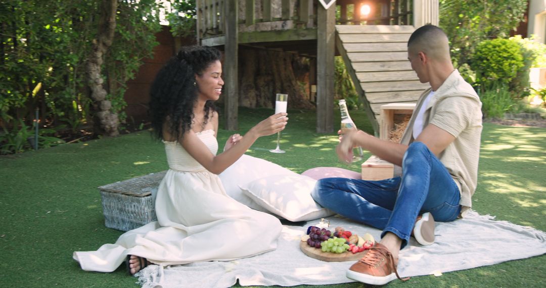 Romantic Picnic with Couple Sharing Drinks and Fruit Outdoors