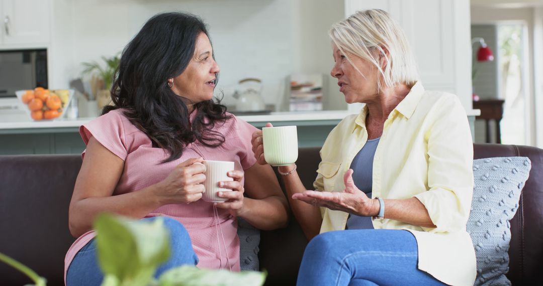 Mature women enjoying friendly conversation over coffee at home - Free Images, Stock Photos and Pictures on Pikwizard.com