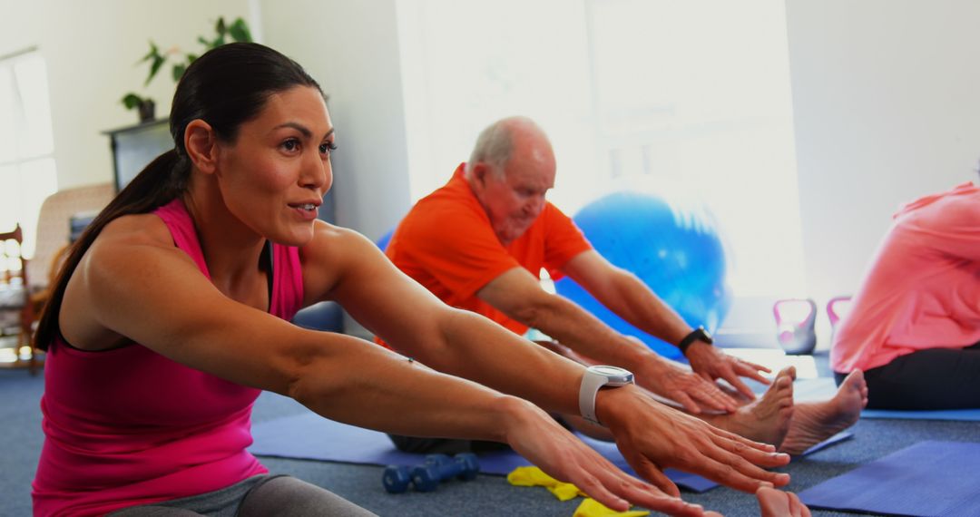 Trainer Leading Senior in Fitness Exercise Session