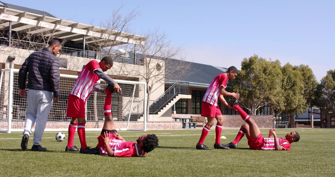 Soccer Players Demonstrating Teamwork and Assistance on Field