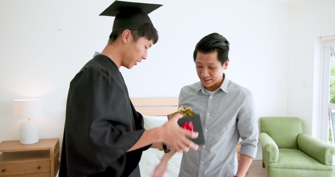 Graduate Hugging Family Member and Celebrating Achievement at Home