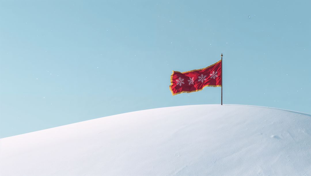 Red Decorative Flag Fluttering on Snowy Crest with Gold Trim and Snowflakes