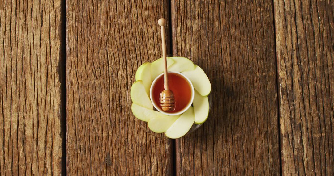 Honey and Apple Slices on Rustic Wooden Surface