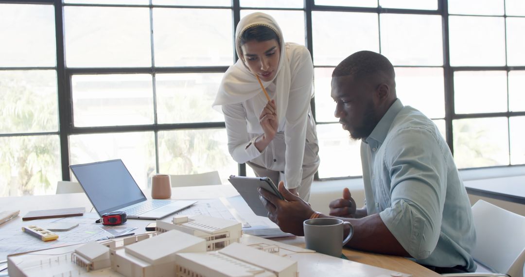 Business Colleagues Collaborate Using Technology in Office