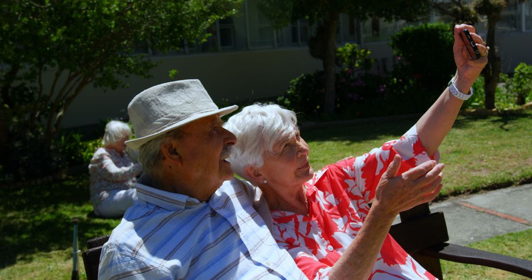 Joyful Senior Couple Taking Selfie in Garden