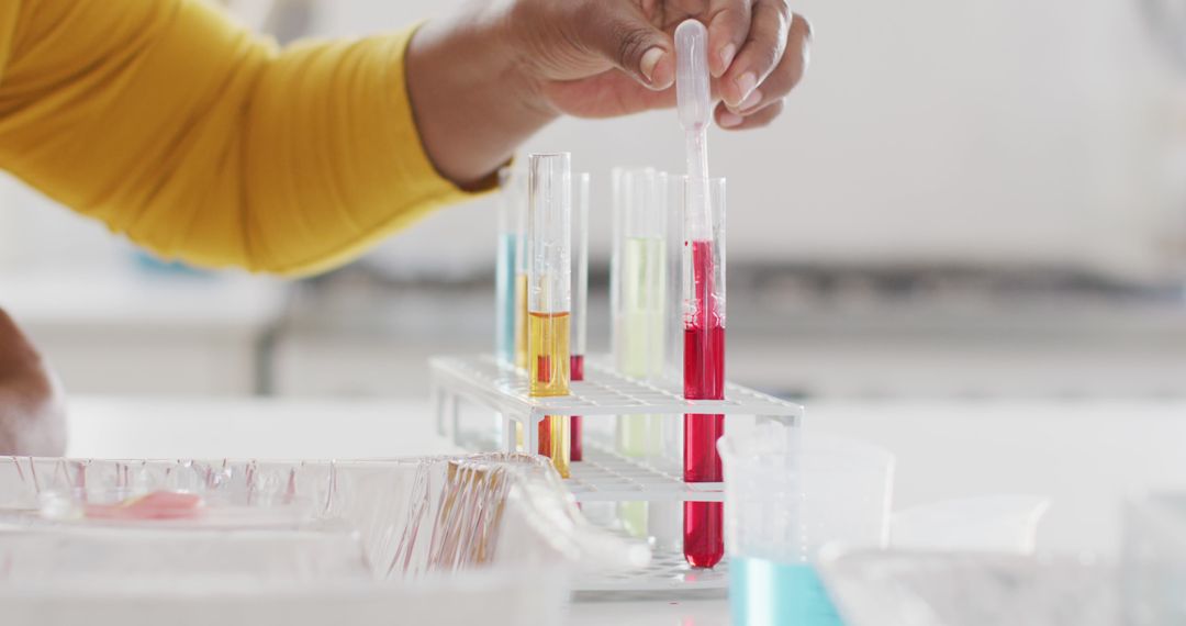 Scientist Handling Test Tubes with Colorful Liquids in Laboratory - Free Images, Stock Photos and Pictures on Pikwizard.com