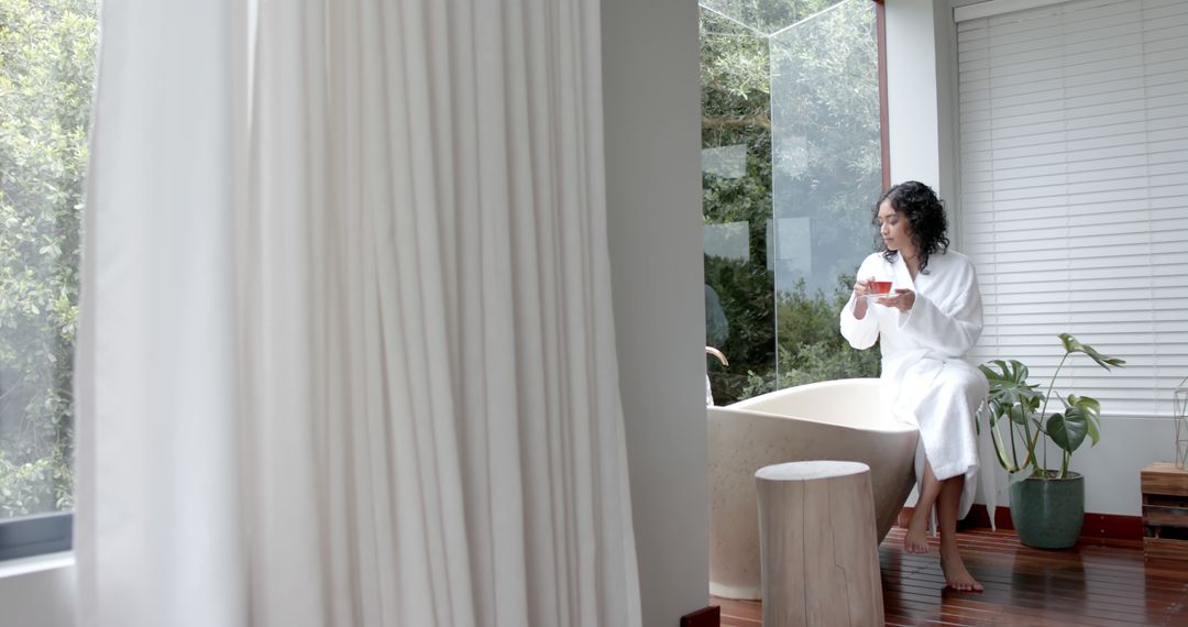 Woman Relaxing in Modern Bathroom Near Large Window - Free Images, Stock Photos and Pictures on Pikwizard.com