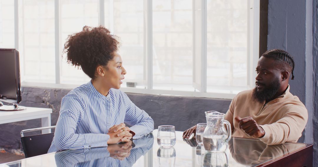 Colleagues Engaged in Meeting Discussion in Collaborative Office