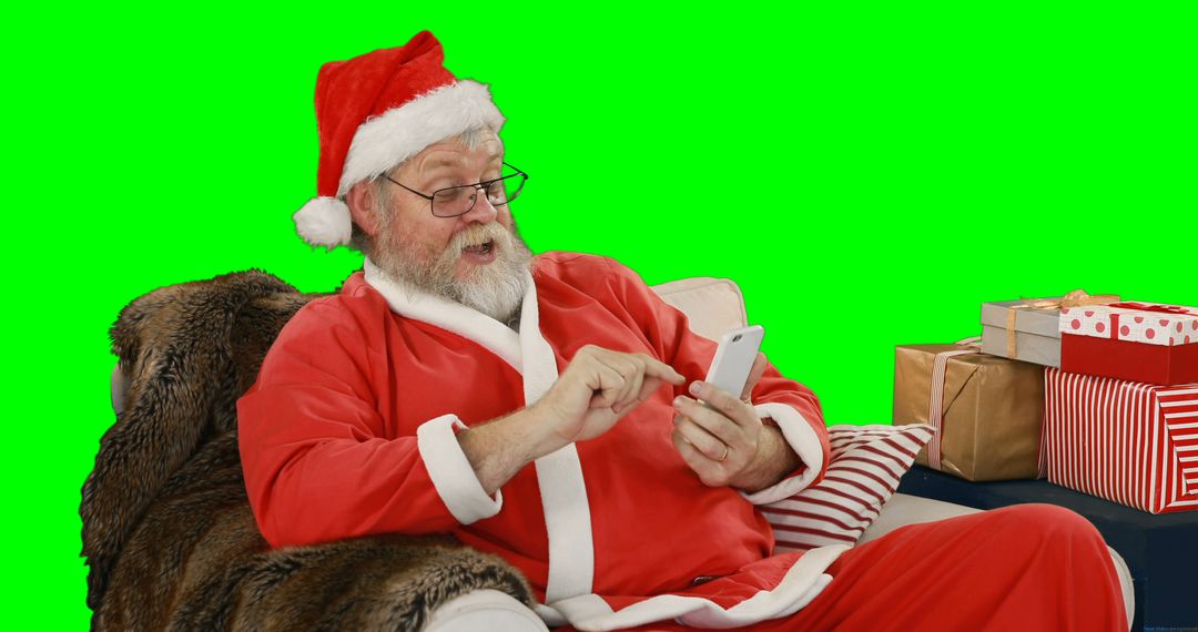 Santa Claus Relaxing and Using Smartphone with Gift Boxes - Free Images, Stock Photos and Pictures on Pikwizard.com