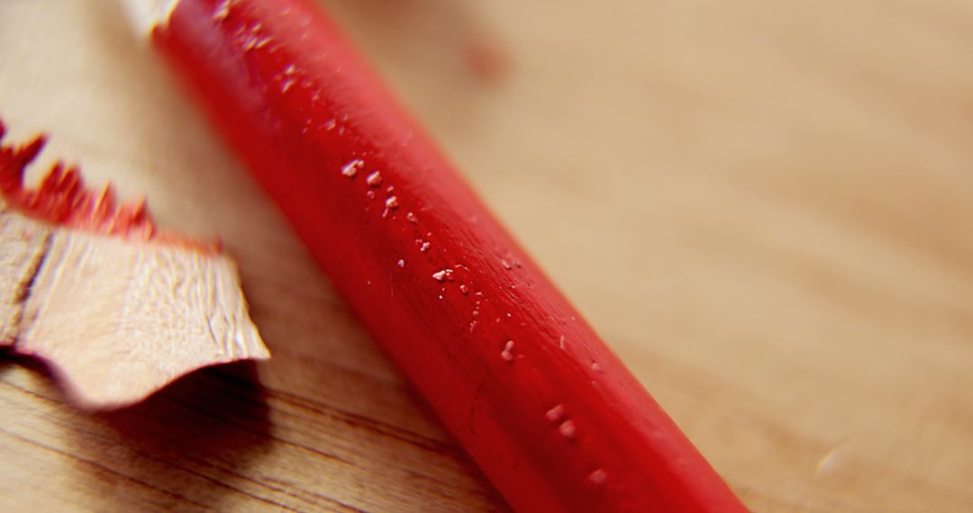 Close-Up of Red Pencil and Shavings on Wooden Surface - Free Images, Stock Photos and Pictures on Pikwizard.com